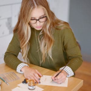 Girl writing calligraphy on paper