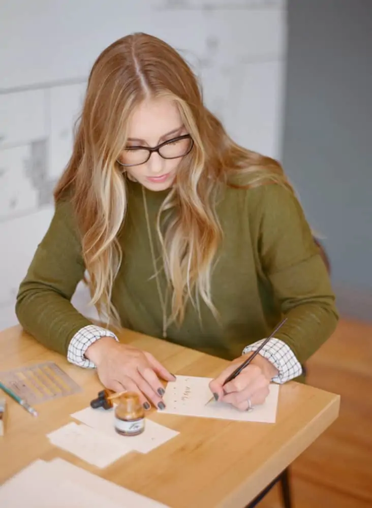 Girl writing calligraphy on paper