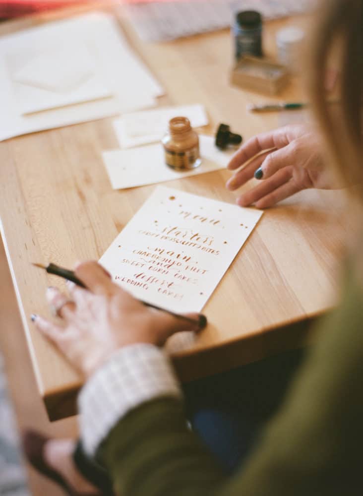 Girl writing calligraphy on paper