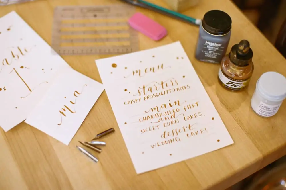Calligraphy writing on paper with supplies