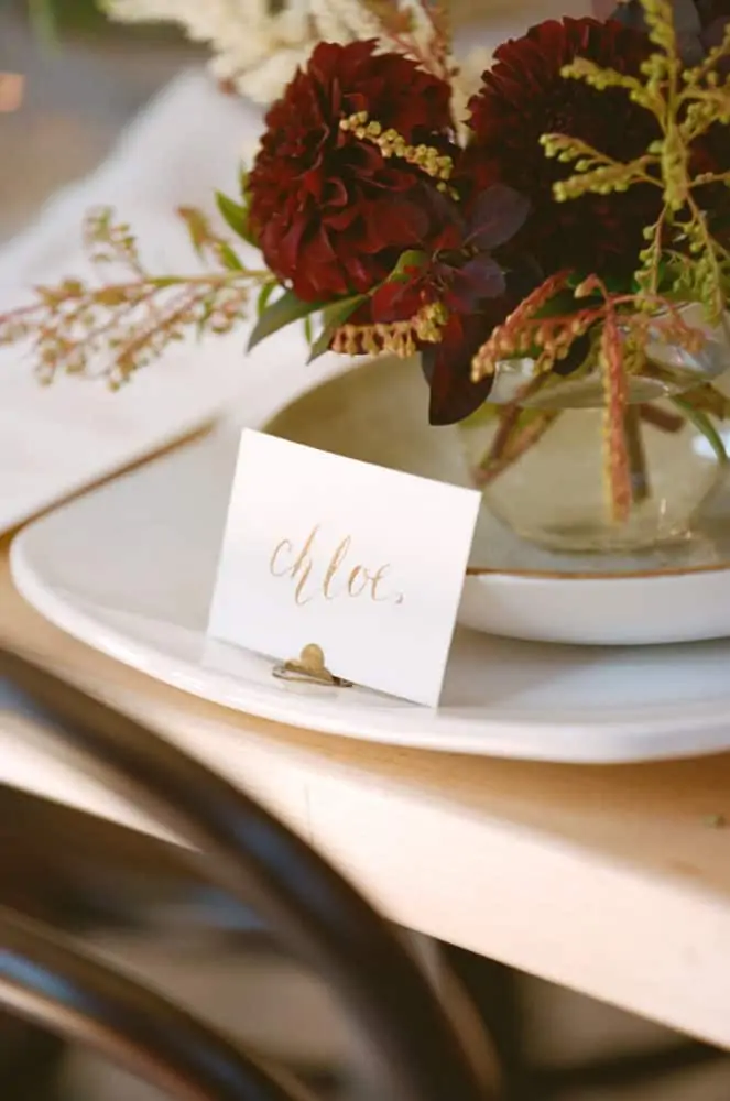 Place setting on plate at table with calligraphy writing.