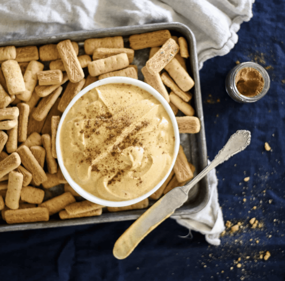 Fall appetizer recipe of pumpkin pie dip in bowl with graham crackers.