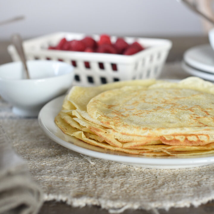 Delicious French Crepes layered on one another with raspberries