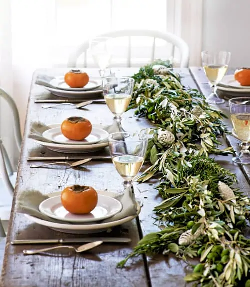 Easy tips and tricks for creating a beautiful, welcoming fall tablescape with natural elements like greenery, veggies, and simple fabrics.  #falltablescapeideas #tablescapes #tablescapeinspiration #falldecor