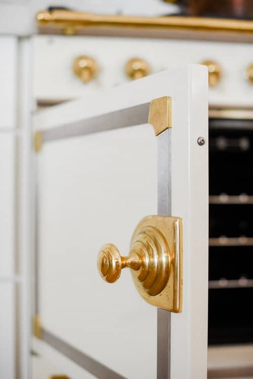 French oven range door with gold handle