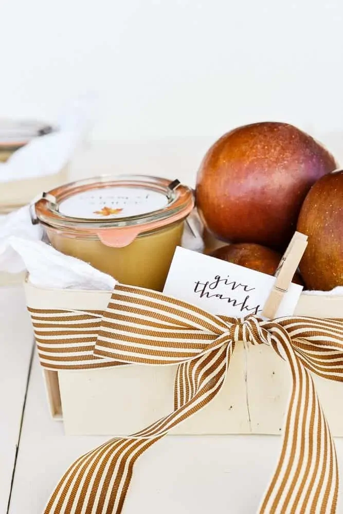 Homemade gift basket for fall with apples and caramel sauce