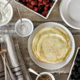 Delicious French Crepes pictured on farmhouse table with berries and other fillings