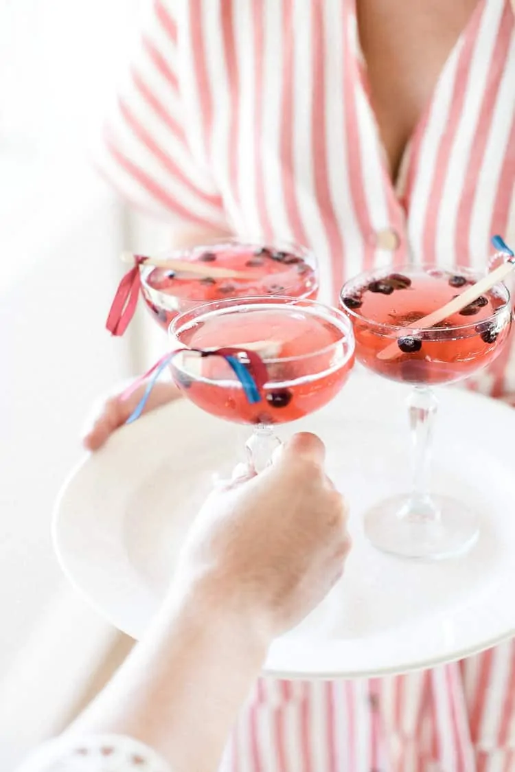 Get the recipe for this easy patriotic champagne cocktail the enjoy on 4th of July! And make sure to check out all of our favorite 4th of July party ideas while you’re here! 