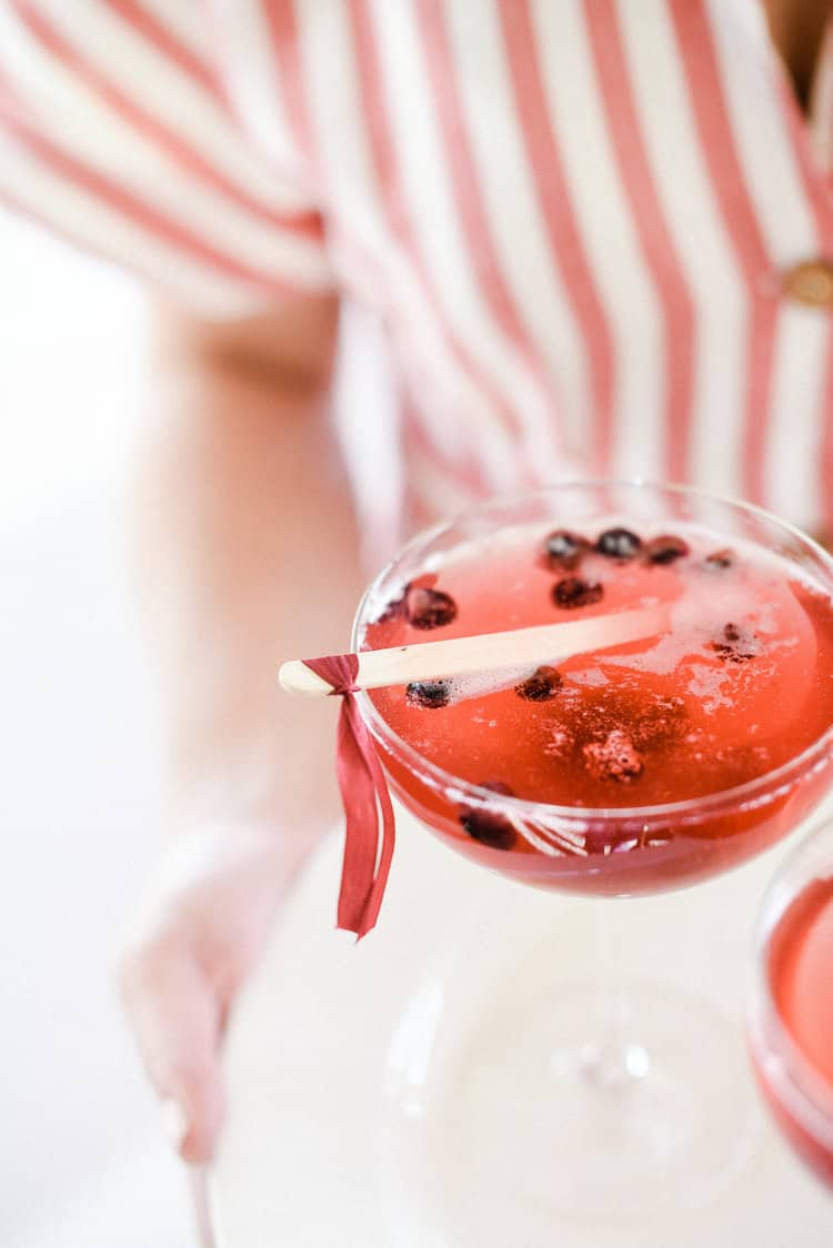 Get the recipe for this easy patriotic champagne cocktail the enjoy on 4th of July! And make sure to check out all of our favorite 4th of July party ideas while you're here! 