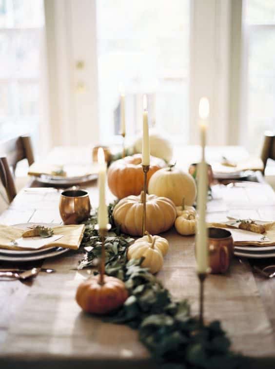 Easy tips and tricks for creating a beautiful, welcoming fall tablescape with natural elements like greenery, veggies, and simple fabrics.  #falltablescapeideas #tablescapes #tablescapeinspiration #falldecor