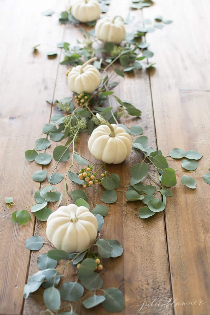 Easy tips and tricks for creating a beautiful, welcoming fall tablescape with natural elements like greenery, veggies, and simple fabrics.  #falltablescapeideas #tablescapes #tablescapeinspiration #falldecor