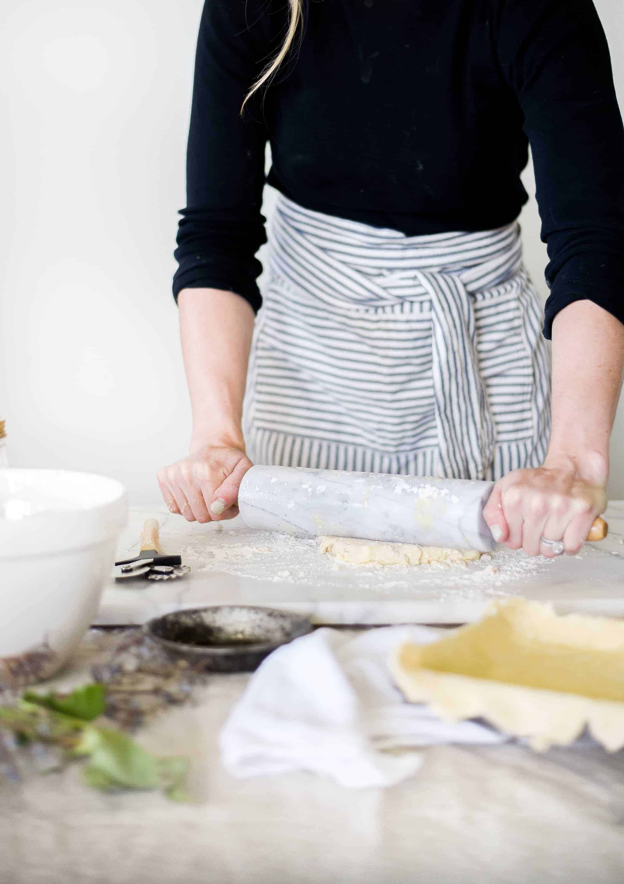 rolling out pie dough for elderberry pie
