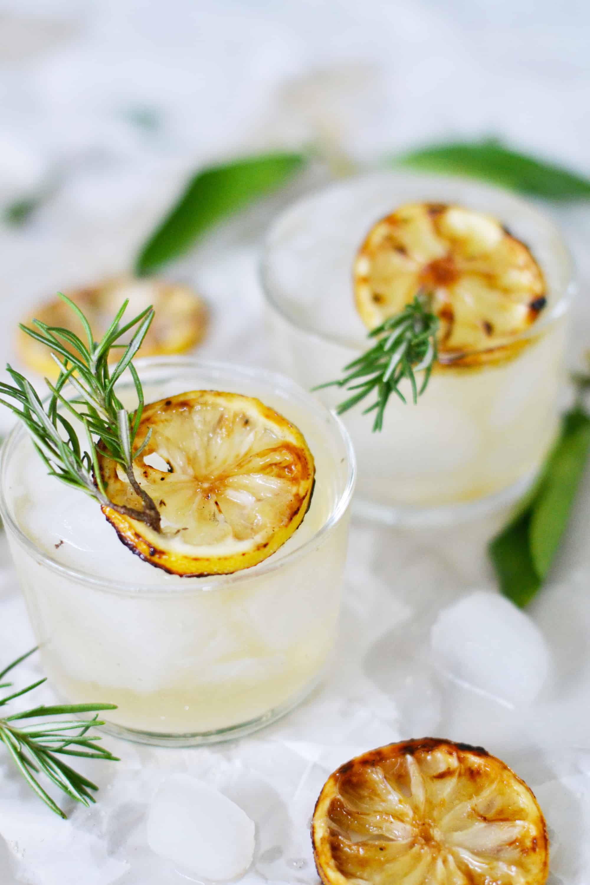 lemon sour cocktail with rosemary and lemon slices