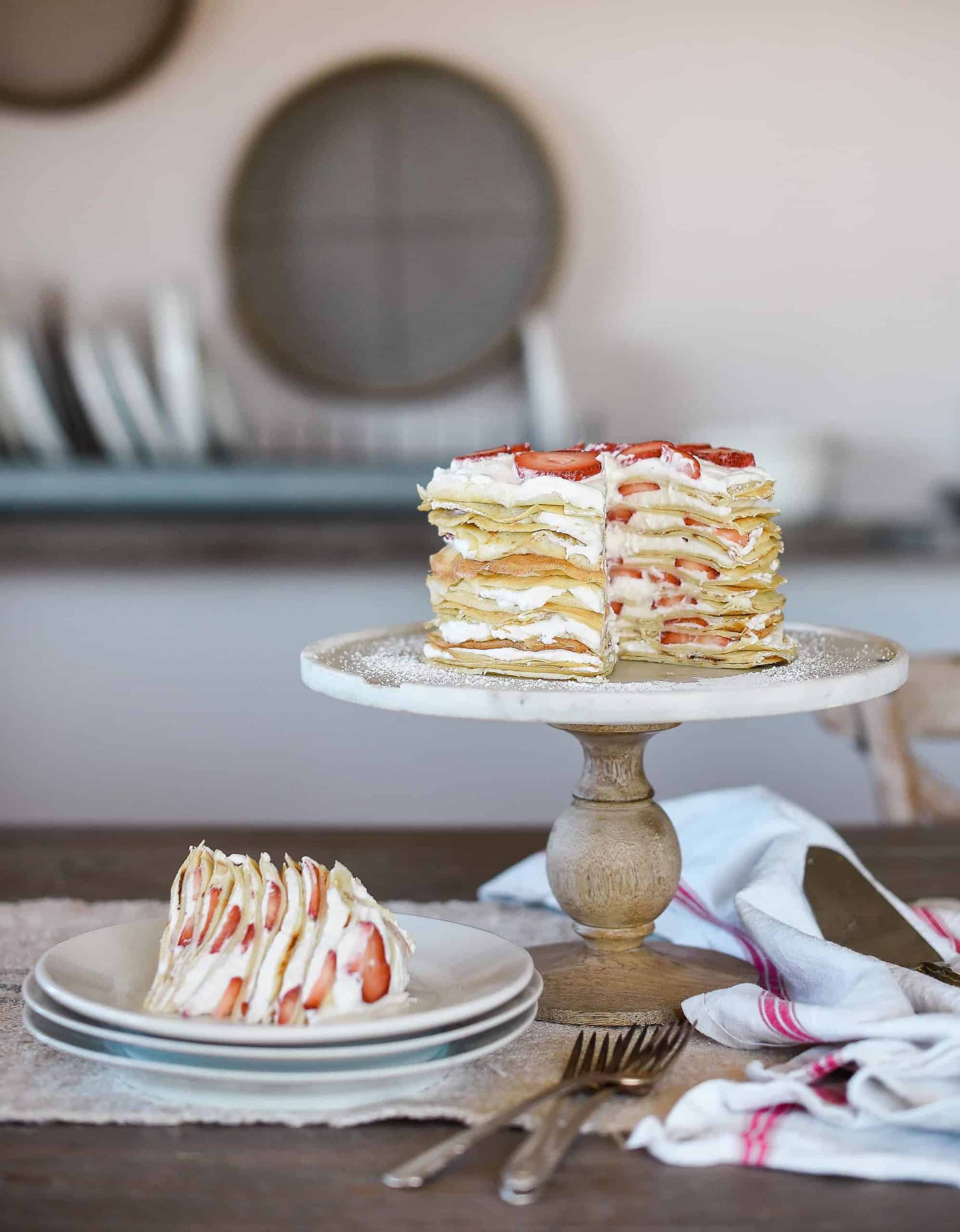 This crepe cake recipe is a show-stopper, and is perfect for special occasions! The cake is made of delicate crepes and filled with strawberries & whipped cream!