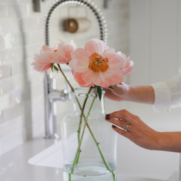 Pink peonies in glass vase in farmhouse kitchen boxwoodavenue.com