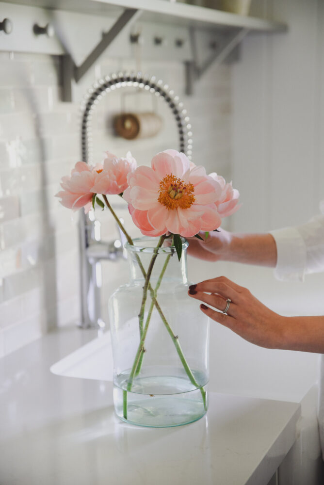 Pink peonies in glass vase in farmhouse kitchen boxwoodavenue.com