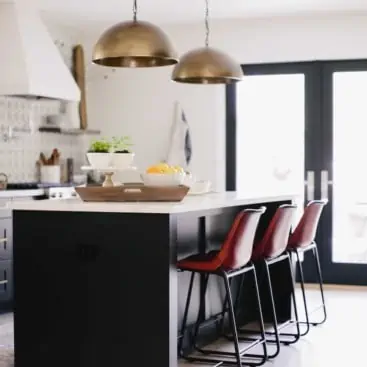 Kitchen Remodel with Dark Island and Brass Pendant with Leather Stools