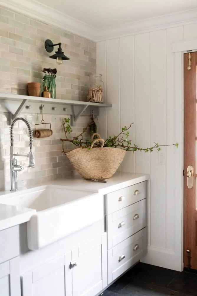 Laundry Room with grey cabinets and white walls