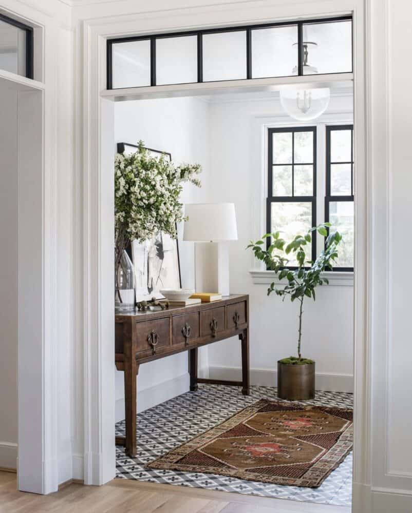 Entryway with Patterned tile and vintage rug by Anderson Wier Studio