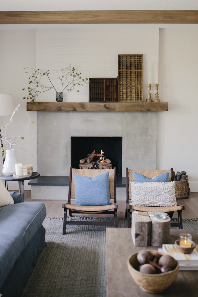 Cement fireplace with rustic wood mantel