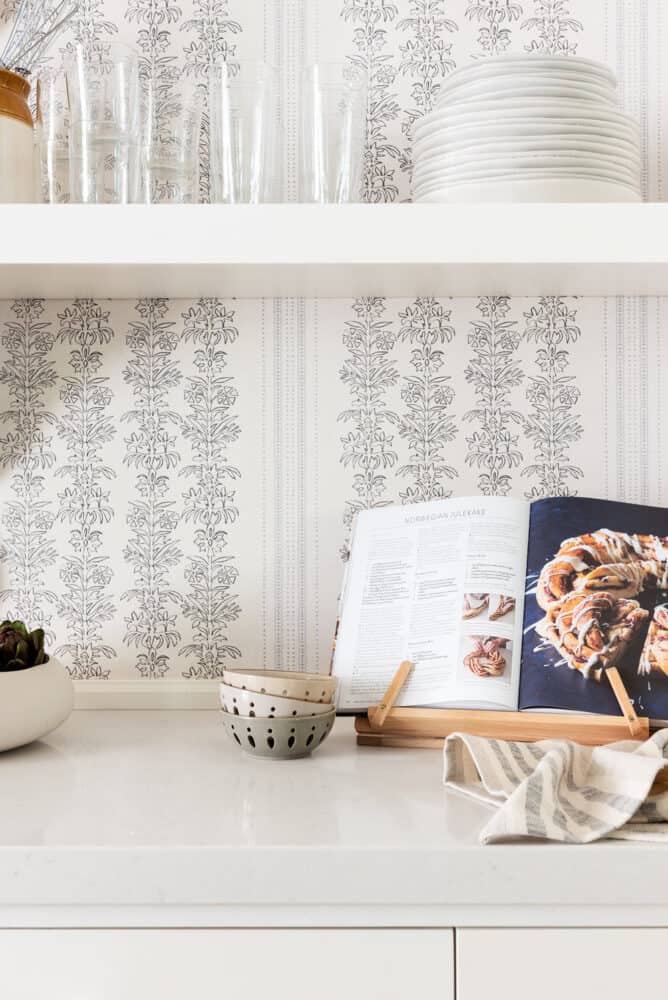 Wallpaper background in kitchen vignette with floating shelves by Studio Mcgee