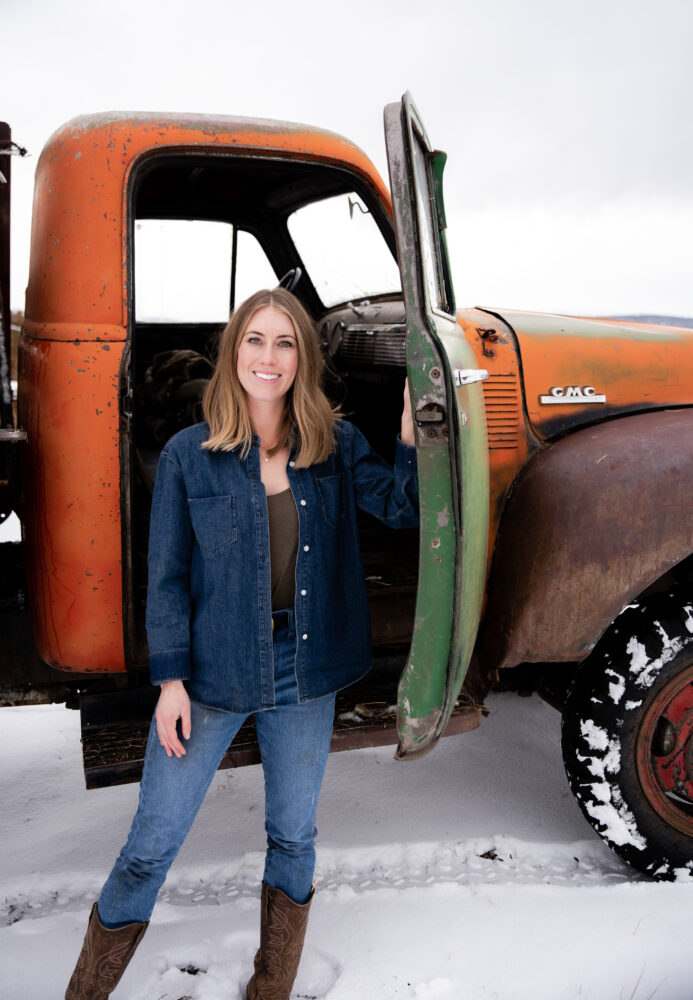 Cowgirl in hay feed truck old GMC