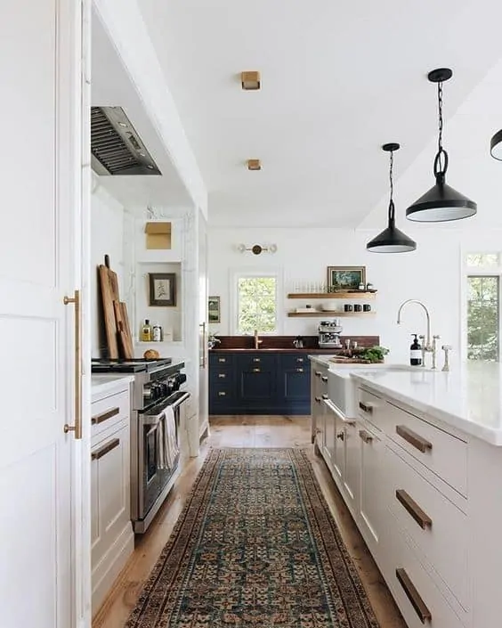 Large white kitchen with black and brass accents