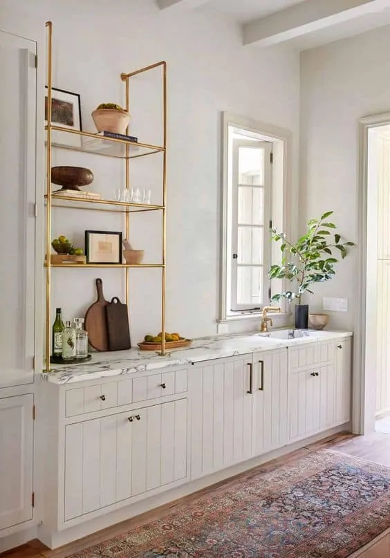 Beige cabinets with brass pipe open shelving