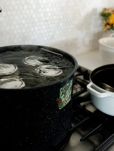 preserving bread & butter pickles in boiling water over the stove