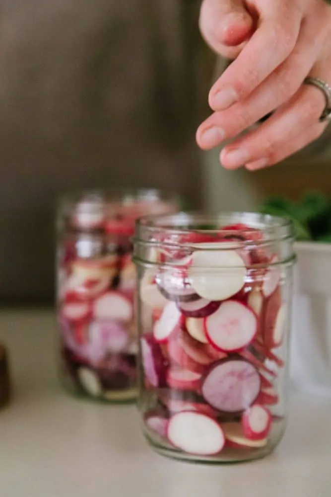 Sliced radishes in mason jars