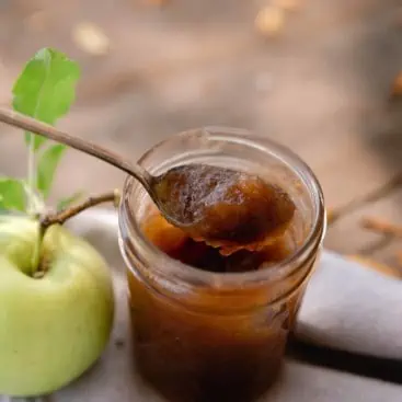 Jar of apple butter on table
