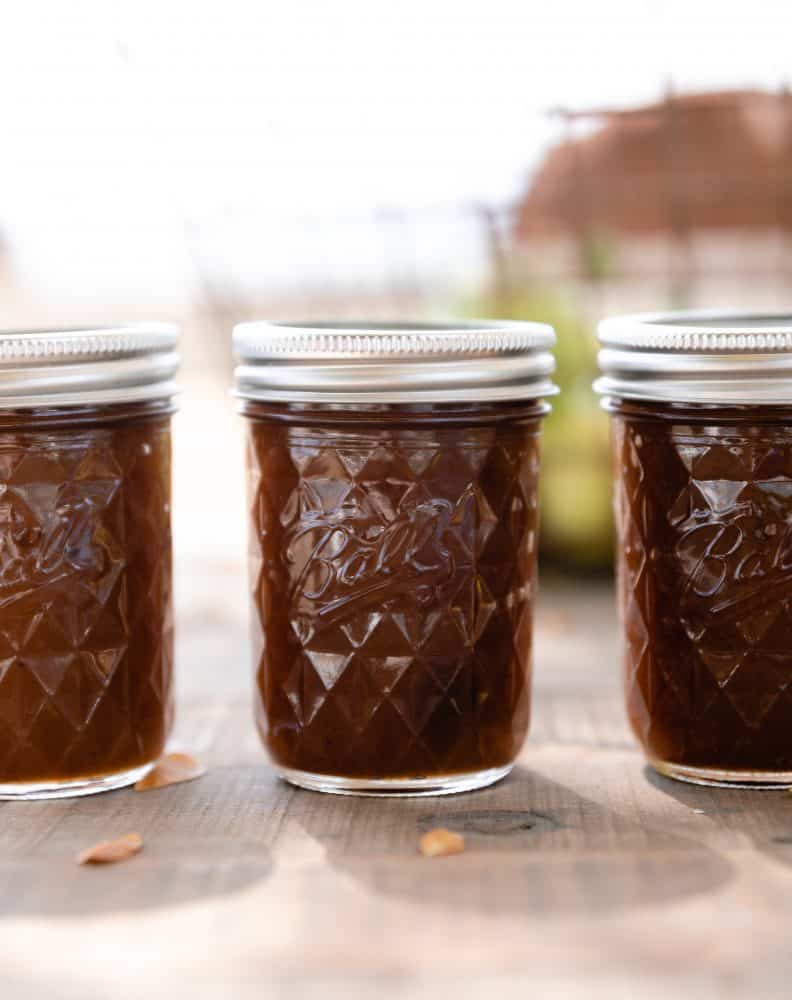 Jars of apple butter on table