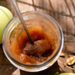 Jar of apple butter on table