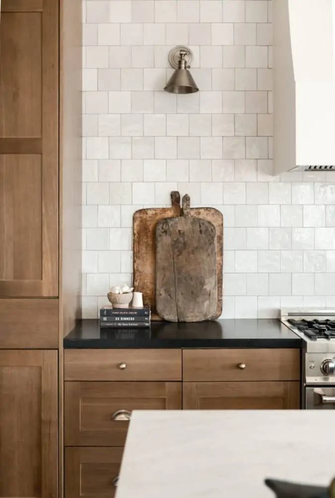 Vintage cutting boards in dream kitchen interior design by Boxwood Avenue Interiors with white oak cabinets Cloe backsplash and marble countertops.