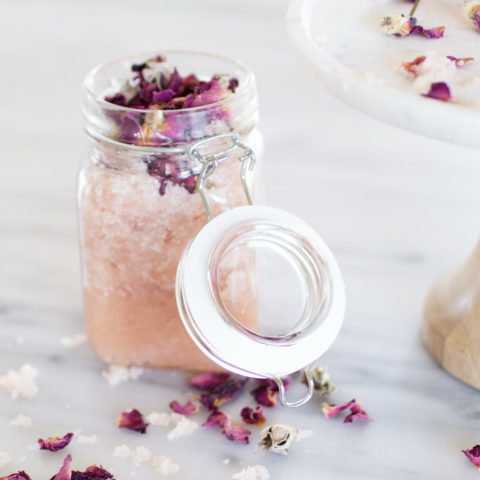 Homemade body scrub on marble countertop.