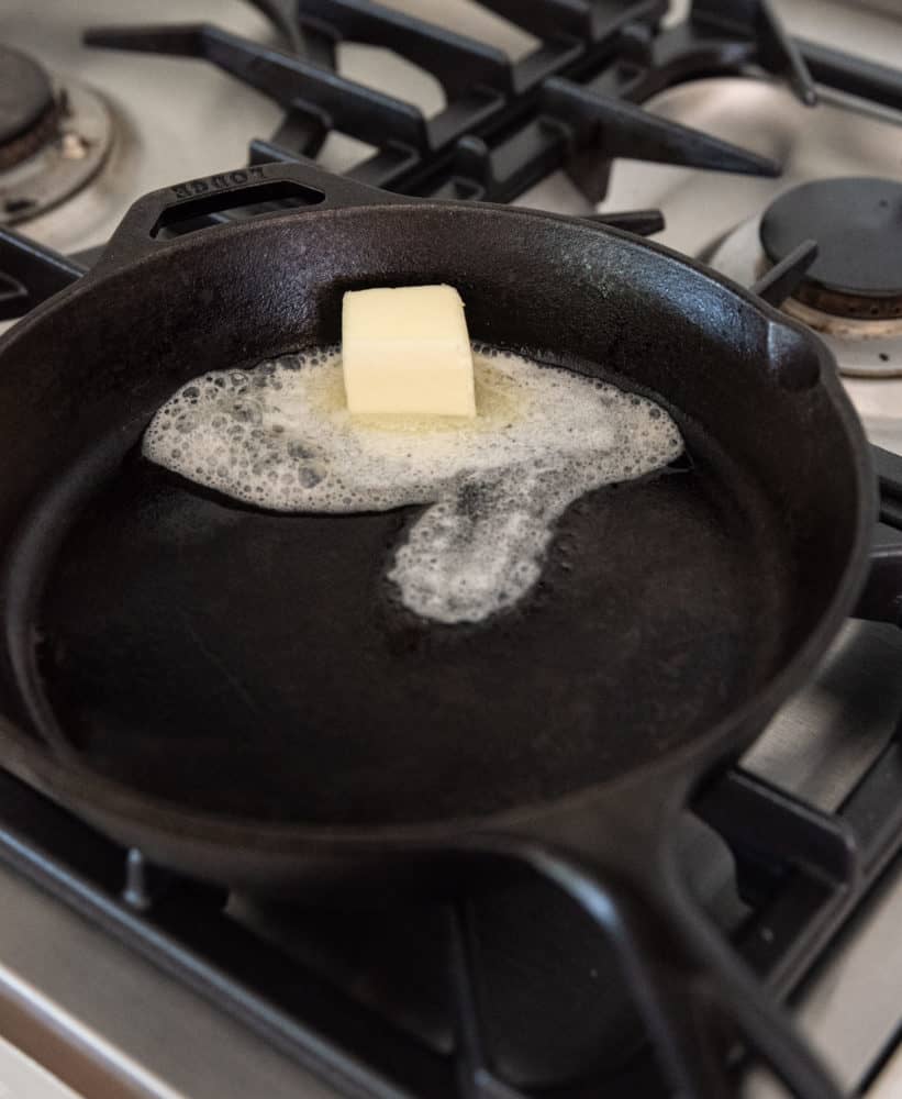 Melting butter in cast iron skillet for dutch baby pancakes.