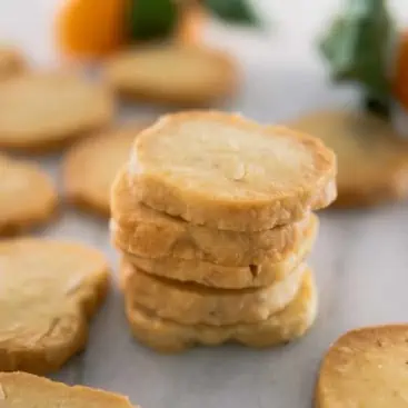 Stack of Orange Shortbread Cookies on Marble Countertop