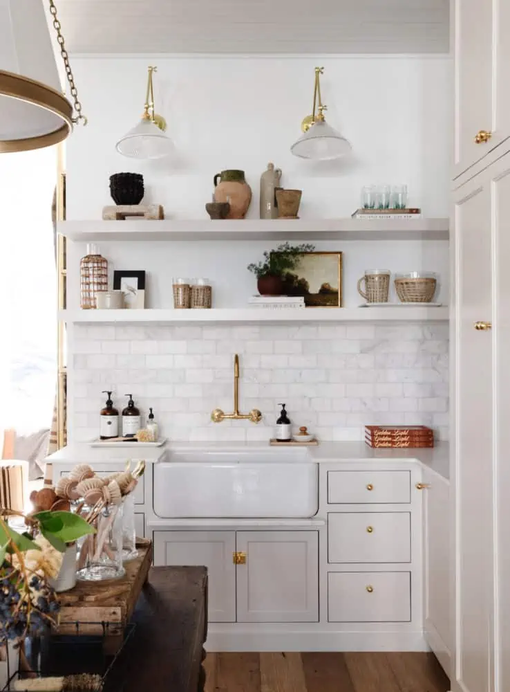 The kitchenette at Boxwood Avenue Mercantile showing beautiful custom insert cabinetry painted Gossamer Veil, one of the best grey paint colors!