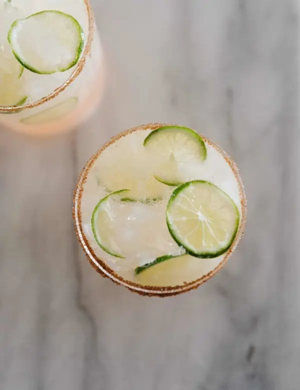 top view of a paloma drink with lime garnishes