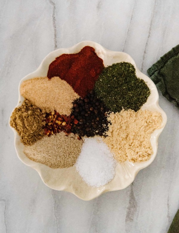 arrangement of spices for steak seasoning in a scalloped edge dish