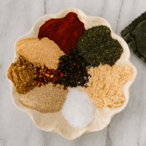 scalloped plate with spices arranged around the edges