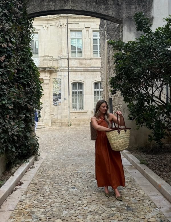 Chloe in the streets of Provence, France with a market bag.