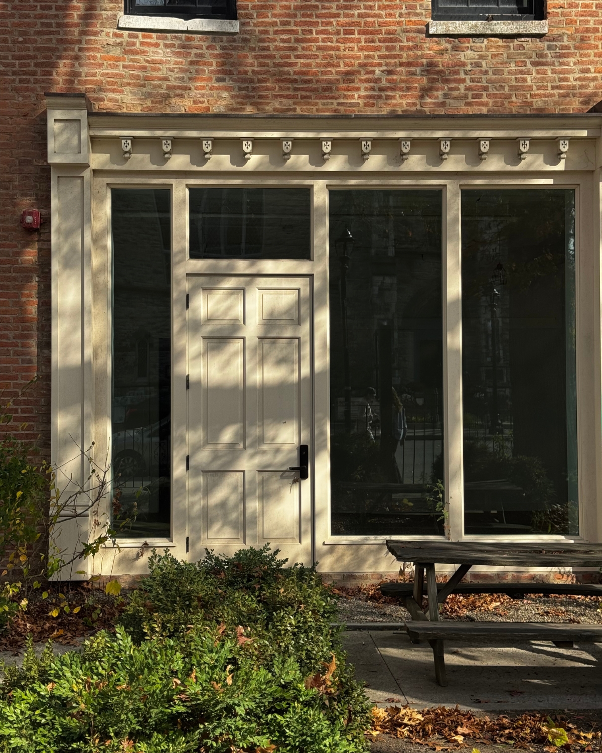 Exterior view of a boutique hotel in Hudson, New York, showcasing its charming architecture and welcoming entrance, surrounded by the scenic beauty of the city's historic district.