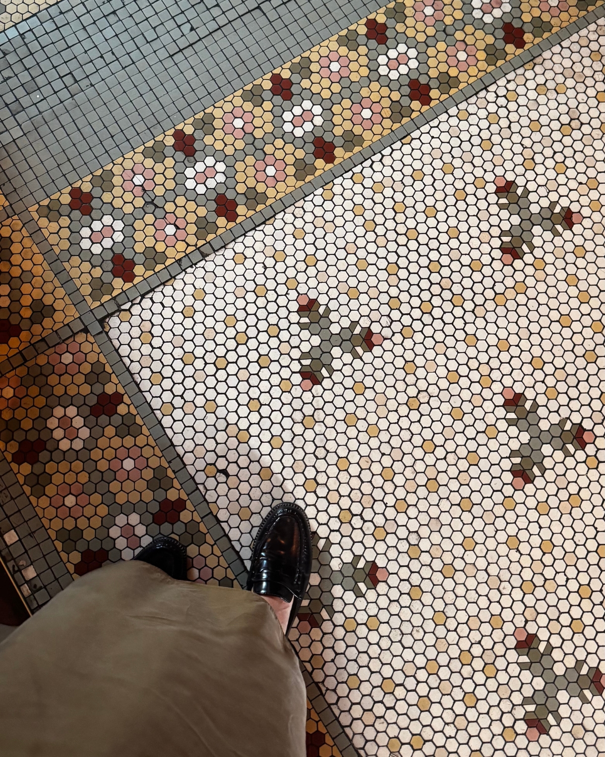 Close-up of a stunning penny-tiled mosaic floor, showcasing intricate patterns and smooth, rounded tiles that create a timeless, elegant look in the space.